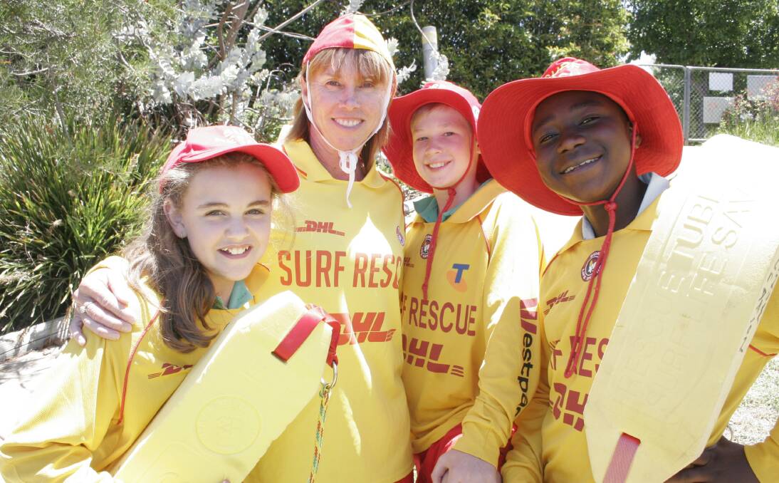 RED AND YELLOW: Lutheran Primary School students Jorja Short, 11, Harry Wilkinson, 12 and Gerrard Okerenyang, 11 with surf life saver Adrienne Lowe following a presentation on the dangers of the ocean. Picture: Declan Rurenga