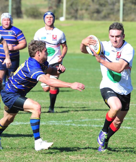 TOO FAST: Albury fullback James Olds runs past his Monaro opposite Matt Caldwell in Southern Inland's big win at Conolly Rugby Complex on Monday. Picture: Kieren L Tilly