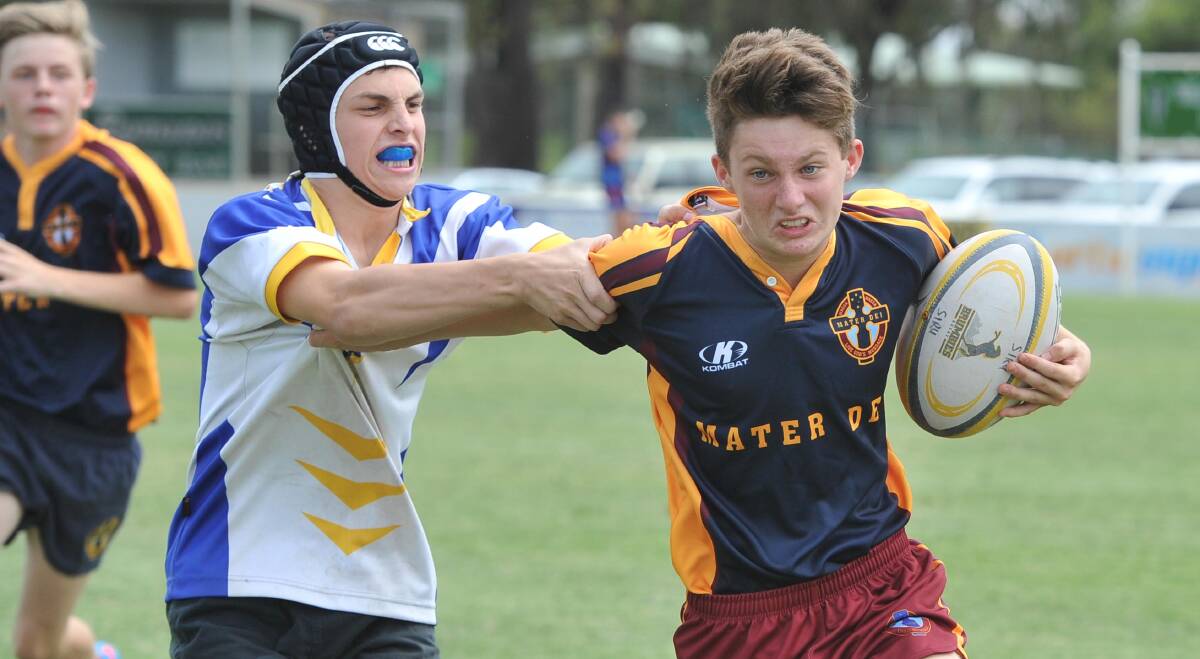 COME BACK HERE: Hennessy Catholic College's Jarrod Livolsi tries to bring down Mater Dei's Bailey Bowyer in the Brumbies sevens tournament.