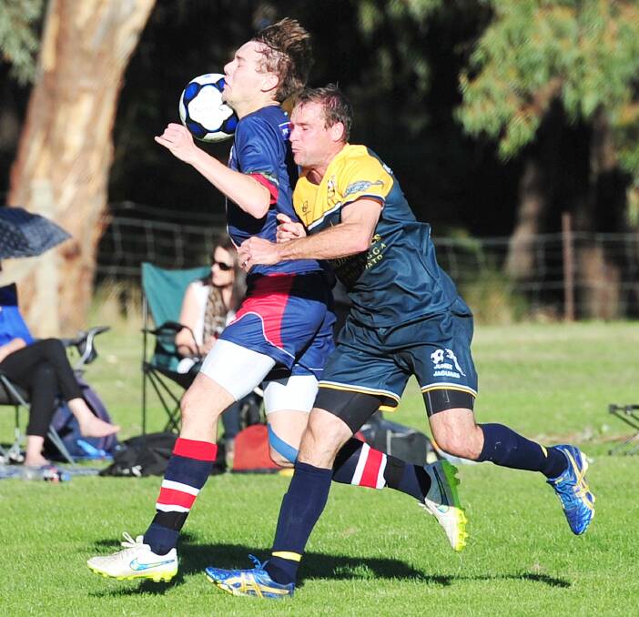 HEAVY CONTACT: Junee's Steven Edwards (left) challenges Henwood Park striker Jake Ploenges in the physical clash between the two team's at Rawlings Park on Sunday. Picture: Kieren L Tilly