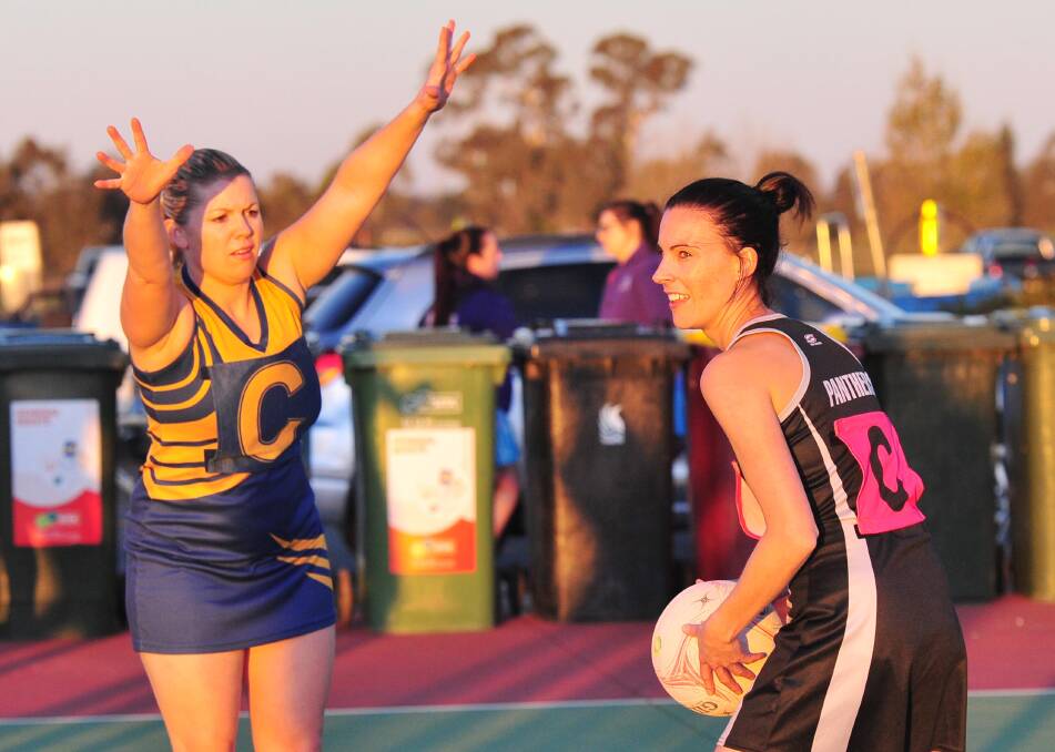 LOOKING FOR OPTIONS: Panthers Kate Garrett (right) looks to get a pass away under pressure from Turvey Park centre Kathryn Fisher on Saturday. Pictures: Kieren L Tilly