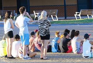 DEVASTATED: Shocked friends and bystanders at the scene of yesterday’s fatality. Pictures: Addison Hamilton