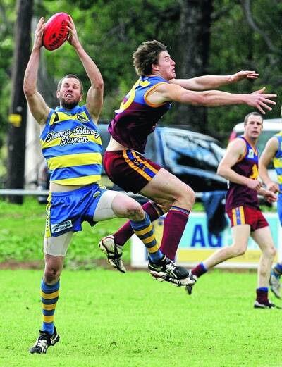 LEAPING INTO ACTION: Mangoplah coach Chris Willis, pictured taking an impressive mark ahead of Ganmain-Grong Grong-Matong�s Jesse Lander, is expecting a tough battle with Riverina Football League newcomer Collingullie-Ashmont-Kapooka on Saturday. Picture: Les Smith