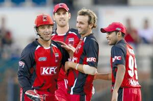 classy debut: Riverina cricketer Nathan Lyon (second from right) is congratulated by Redbacks teammates Graham Manou (left), Shaun Tait (back) and Abdil Rashid after the bowler dismissed Blues opponent Daniel Smith in the Twenty20 Big Bash on Tuesday night.