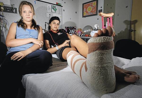 BROKEN: Jacinta Rochecouste,12, (pictured with her friend Amy-Lee Schodde, 12) broke her ankle at the Wagga Christian College sports carnival on Friday and has since had surgery to pin the ankle and growth bone, which was also broken. Jacinta and her mother Caroleen MacColl are upset with the college’s reaction to the accident. Picture: Glenn Henderson