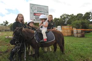 NOT HAPPY: Riders with Wagga and Bidgee District Pony Club (from left) Paige Taylor, 11, Alexandra Cloros, 8, Chavelle Windle, 3, on pony Kadeesha, and Adelaide Cloros, 12, aren�t able to ride at their North Wagga clubhouse after it was destroyed in the floods.	 Pictures: Oscar Colman