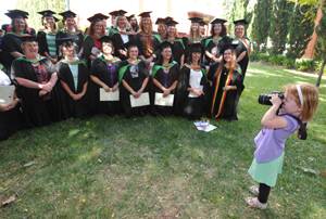 Ella Morris takes a picture of her mum Glenda's library graduating class of 2011.