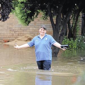 ALL AT SEA: Vestey Street resident Leah Burt joined with fellow residents to assess the damage after savage storms hit the region late on Wednesday and early Thursday morning.