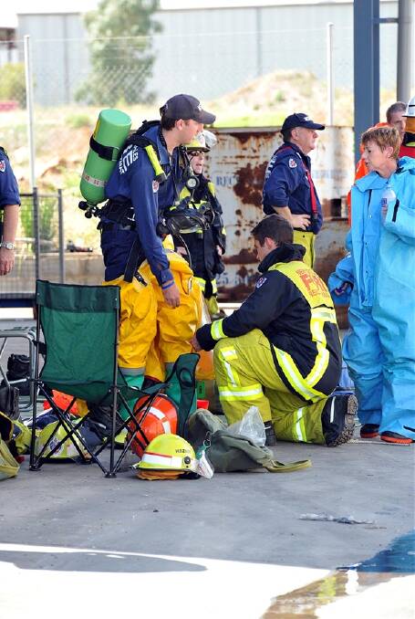 FOUR HOSPITALISED: An unknown hazardous substance left four employees at Kurrajong Waratah needing hospital treatment yesterday. Police, firefighters, a hazmat team and paramedics were called to the business in the hopes of finding what caused the employees to become ill. Picture: Michael Frogley