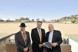 GIANT FOOTBALL FUTURE: Wagga City Council became an official $300,000 partner of the Greater Western Sydney Giants (GWS) yesterday.  Council general manager Phil Pinyon (left), GWS chief operating officer Richard Griffiths and mayor Kerry Pascoe get ready to finalise the agreement. Picture: Oscar Colman