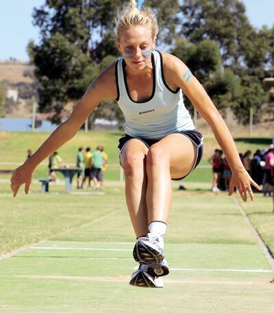 STAR PERFORMER: Wagga High School student Jess McEwan launches herself forward in the 16 years long jump at Jubilee Park yesterday.