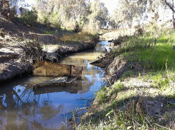 WASTELAND: Wagga City Council has denied responsibility for cleaning up Marshalls Creek, saying it isa state asset. Residents are fed up with seeing the area littered with rubbish, car parts and a trolley.