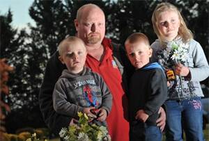HARSH POLICY: David Rutland and his children Cameron (left), Adam and Jessica are disappointed they will not be able to leave toys on the graves of their loved ones after Wagga City Council anounced it would remove all toys, statues and glass vases from graves at the cemetery. Picture: Oscar Colman