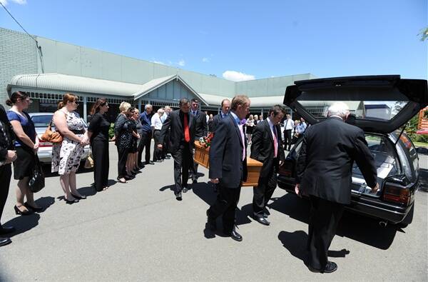 HONOURED: Ross Ingram’s coffin is carried through a guard of honour made up of past and present staff of The Daily Advertiser. The pall bearers (clockwise from front left) were: Peter Mahoney, Scott Sanbrook, James Langlands and Daniel Sharpe. Picture: Addison Hamilton