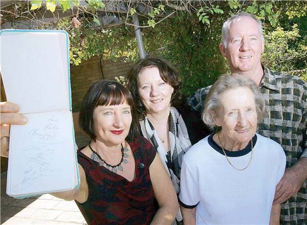 BEE GEE FEVER: The Bartholomew family, (from left) Julie, Deborah, Jean and Robert show off their treasured autograph book containing the signatures of Barry, Robin and Maurice Gibb, the Bee Gees, who stopped in Wagga at their father’s car repair business in 1966.