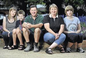 FAMILY MATTERS: The Harmers are a close family who will hope to bring about change in Canberra today. Chris and Carol Harmer (centre) will share their story of raising three children, two of which have a rare disability. Pictured is (from left) Lauren, 20, Tom, 15, and Emily, 19. 	Picture: Michael Frogley