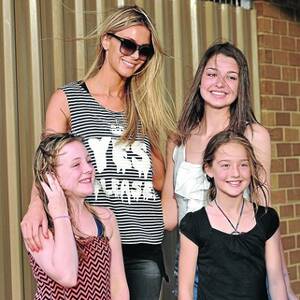 DREAM COME TRUE: (From left) Kaylah Faulkner, 10, Olivia Deen, 15, and Phoebe Deen, 10, pose for a photo with former Miss Universe Jennifer Hawkins at Narrandera airport. Ms Hawkins will be in Narrandera for the next few days shooting the upcoming Myer winter catalogue. Picture: Oscar Colman
