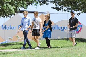 IN SHOCK: Dozens of teenagers arrive at Mater Dei Catholic College for a prayer service for their mate, Lachlan Burgess.