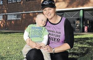 RUNNING FOR LOVE: Wagga mother Kelly Lawson is set to run a half-marathon on Sunday to raise money for hospital equipment to assist premature babies, like her 16-month-old son Nate. The pair are pictured at Wagga High School yesterday.  