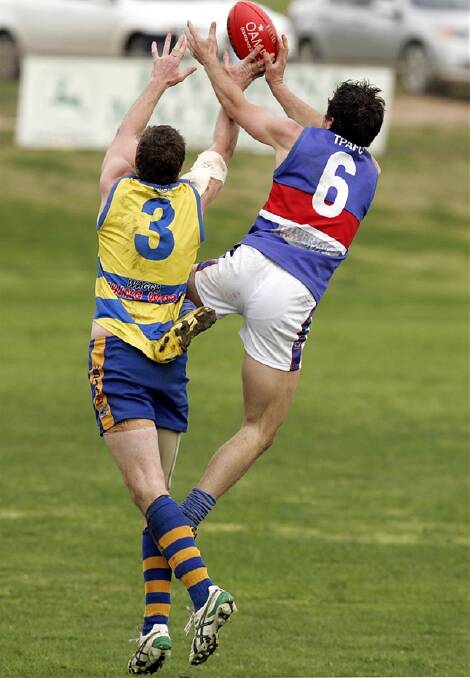UP FOR GRABS: Mangoplah-Cookardinia United-Eastlakes' Sam Balding contests in the air with Turvey Park's David Johnson in yesterday's preliminary final at Narrandera Sportsground. Pictures: Oscar Colman