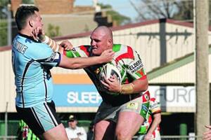 TOUGH CUSTOMER: Tumut prop Anthony Coyle (left) comes to grips with bush champion Grant Wooden.