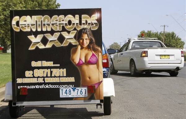 TOO RACY: A saucy sign for escort agency Centrefolds XXX was parked in a visible location on Hammond Avenue in Wagga yesterday. Wagga City Council says the sign is illegal and has issued an infringement notice and an order of removal.  Picture: Glenn Henderson