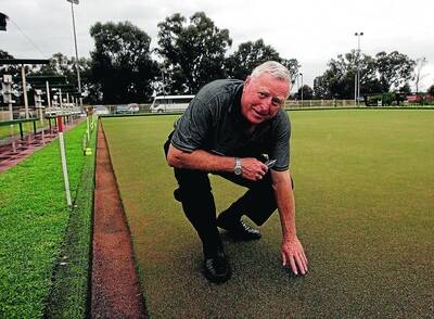 INSPECTION: Rules Club lawn bowls expert Doug Murray checks out a green at the Wagga club yesterday. Picture: Oscar Colman