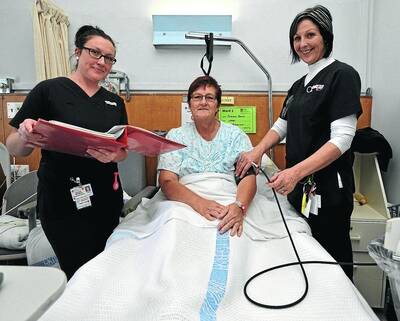 A BIT OF TLC: The hard work of nurses, including Wagga Base Hospital nurses Hannah Thompson (left) and Jenie Waters (right), will be recognised today for International Nurses Day. The pair are pictured with patient Dianne Boyle, from Coleambally. 	Picture: Les Smith