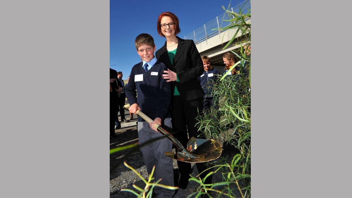 Prime Minister Julia Gillard and Tom Heriot from St Patrick's School in Holbrook plant a tree at the southern end of the bypass. Picture: Michael Frogley