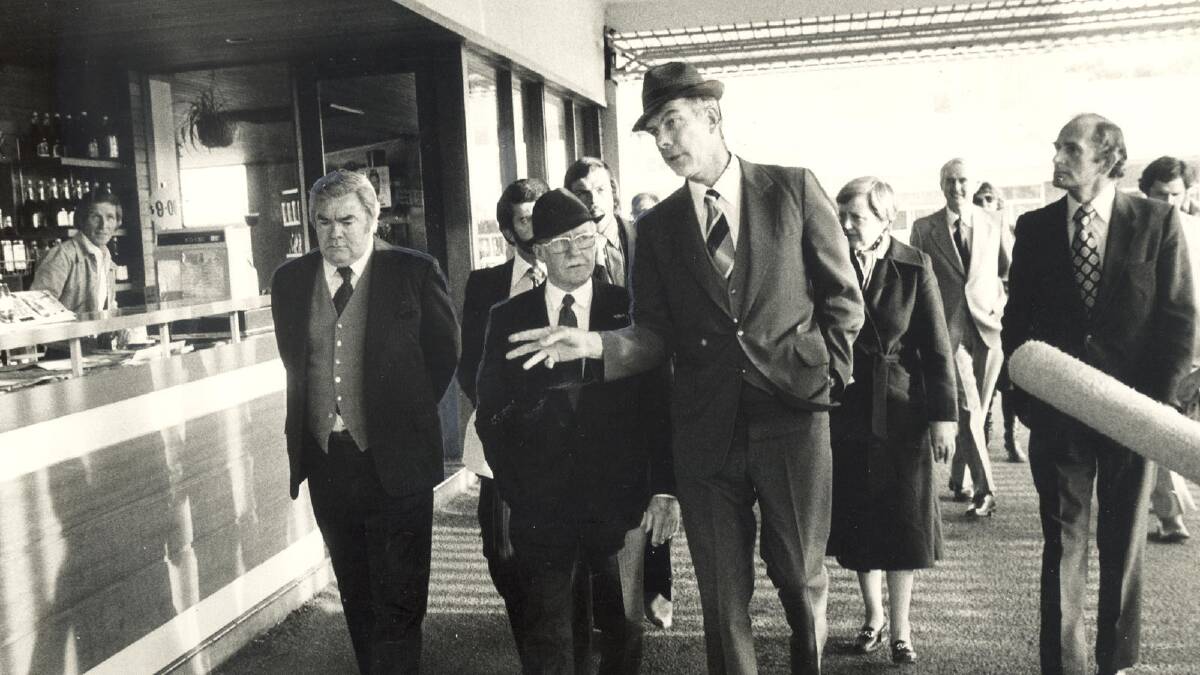 Justice Woodward (second from left) inspects the car park of the Griffith Hotel where Mr Don Mackay disappeared.