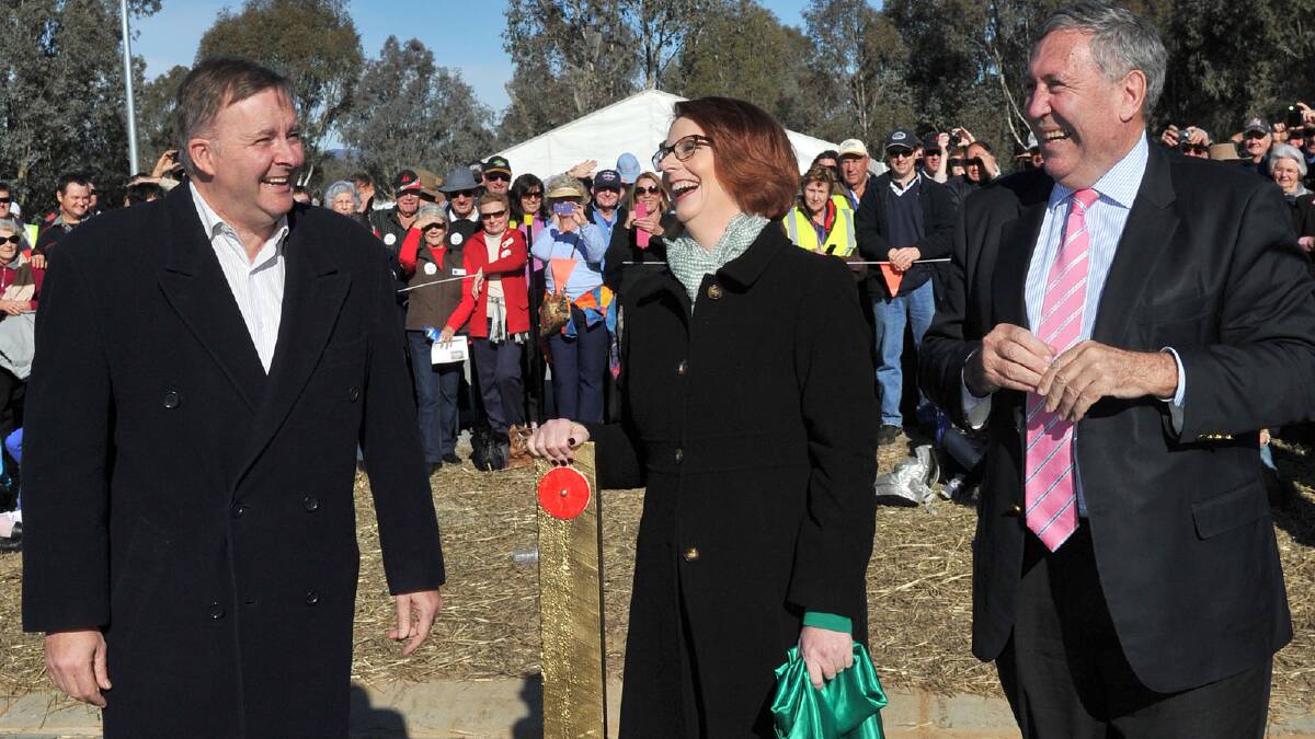 Minister for Infrastructure and Transport Anthony Albanese, Prime Minister Julia Gillard and NSW Minister for Roads and Ports Duncan Gay share a light-hearted moment following the unveiling of the golden guidepost. Picture: Michael Frogley