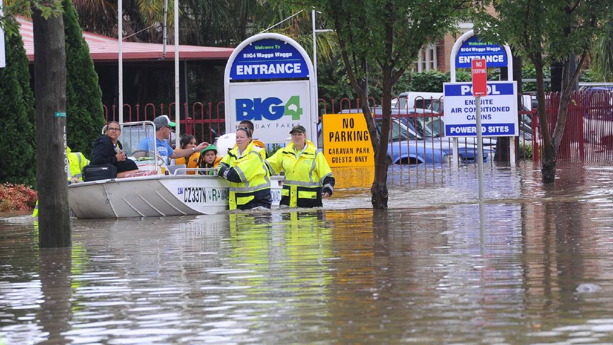 People were evacuated by boat from the Big4 Caravan Park. Picture: Addison Hamilton
