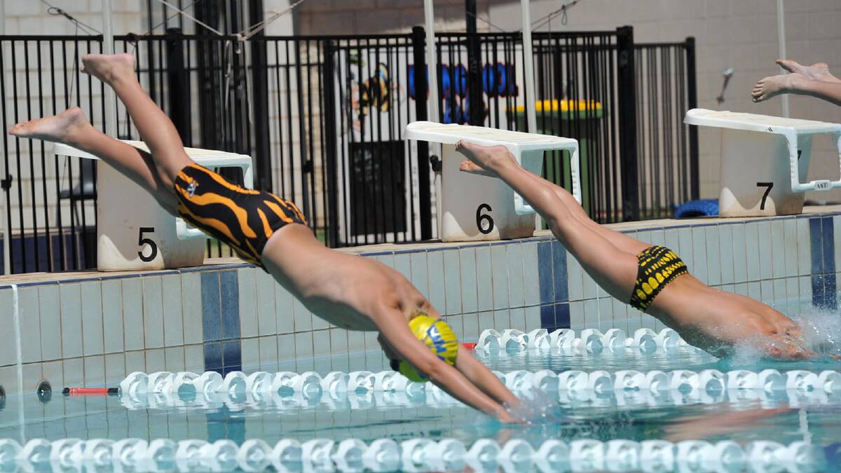 Good mates and close rivals Brodie Senior and Rex Gallaher, both 11, dive in for their showdown in the 50m freestyle. Picture: Michael Frogley