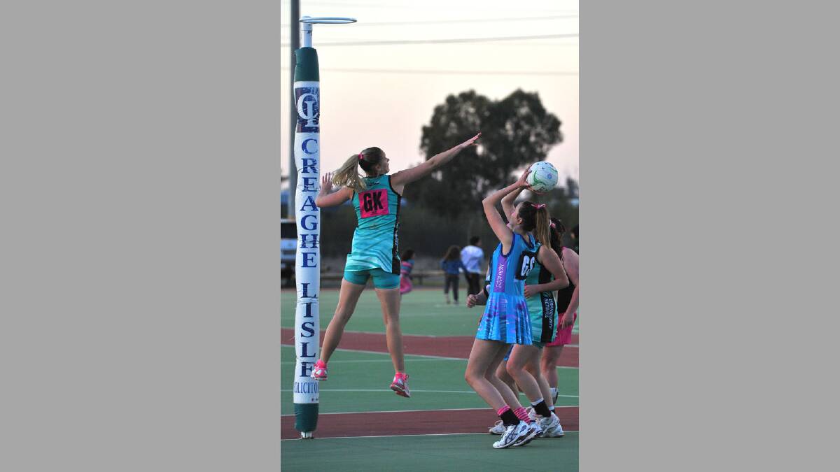 First grade netball. New Kids Diamonds v Uranquinty. Uranquinty's Brydee Clarke jumps to try block a shot from New Kids' Alison Miller. Picture: Addison Hamilton