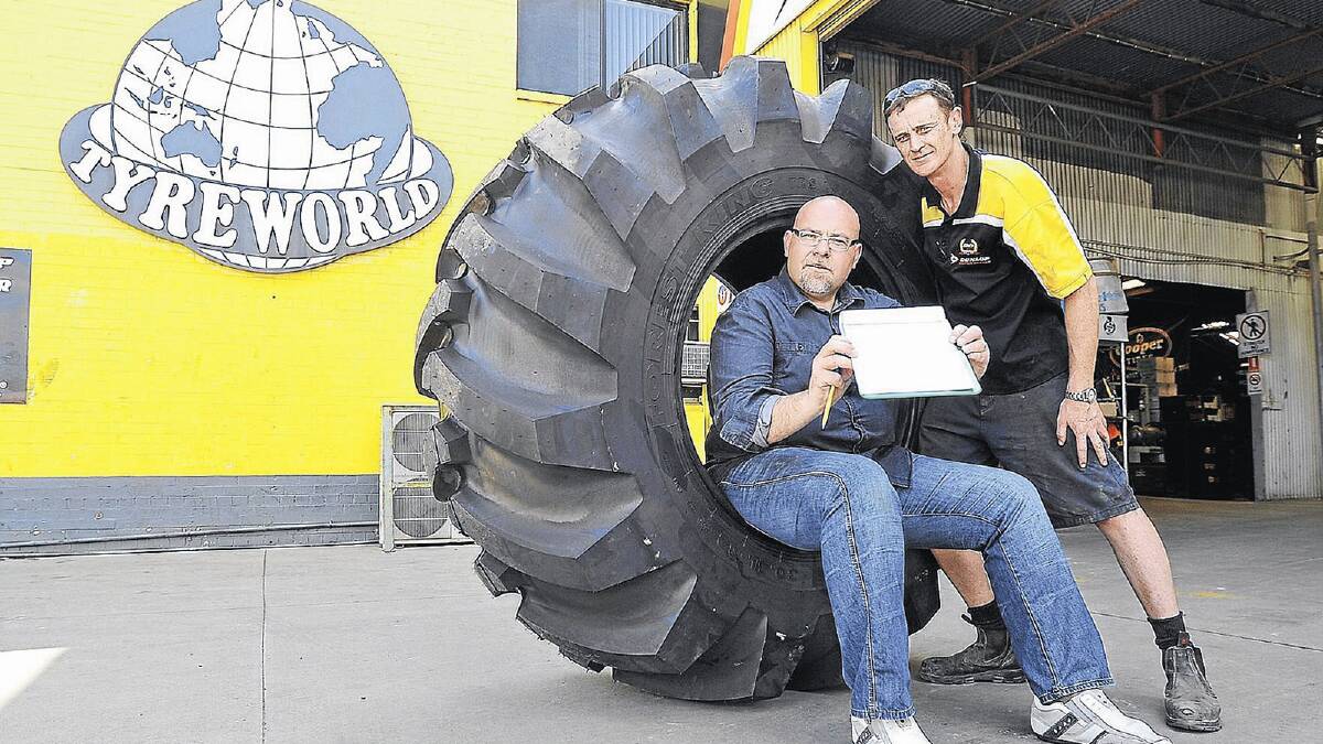 BUY US SOME TIME: Wagga businesses, including Tyre World represened by Graeme McKeown (right), are getting behind a community petition to support Telstra Child Flight. Secretary of the Child Flight board Matt Hogg (left) is encouraging people to sign. Picture: Oscar Colman