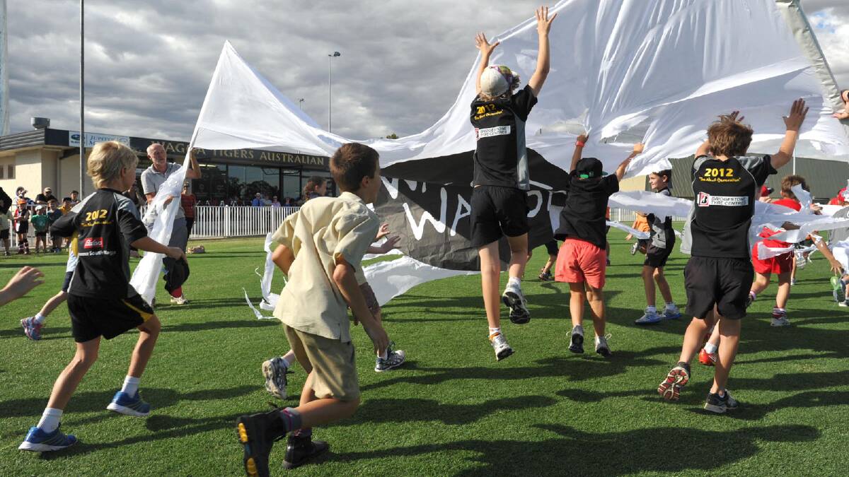 BREAKING NEW GROUND: Kids had a chance to run through the first banner at the official opening of the upgraded Robertson Oval yesterday. Picture: Les Smith