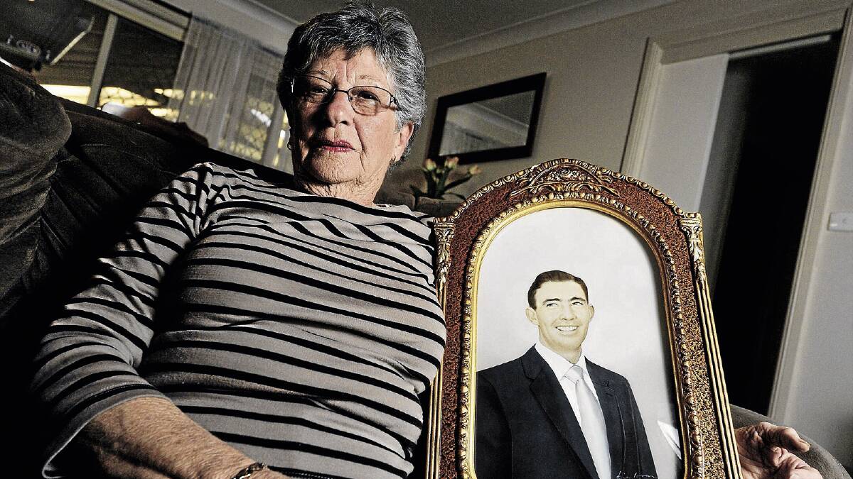 PASSAGE OF TIME: Widow Margaret Carroll holds a photograph of her late husband Gerald. Picture: Alastair Brook