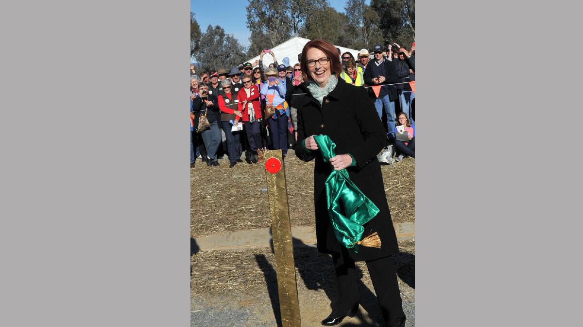 Prime Minister Julia Gillard unveils the golden guidepost. Picture: Michael Frogley