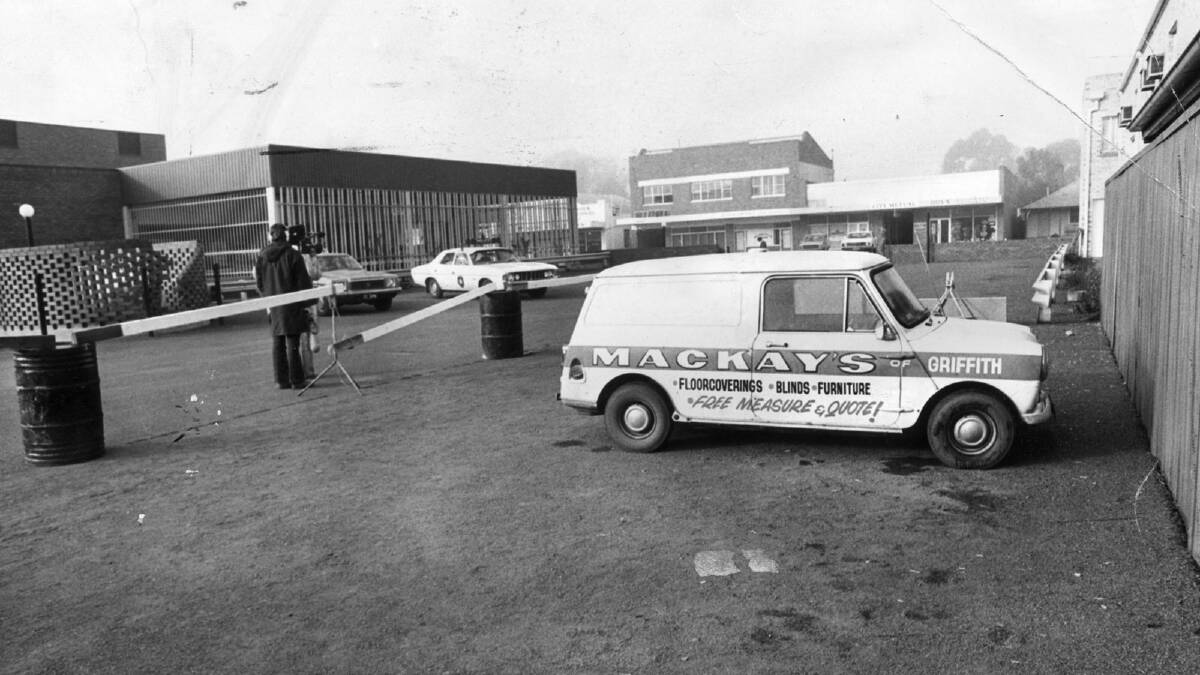 Police create a crime scene around Donald Mackay's mini-van, pictured in the car park of the Griffith Hotel, where he was last seen in 1977.