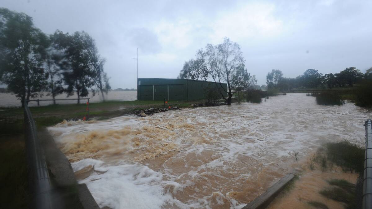 The storm water drain across from Lake Albert gushes with flood water. Picture: Addison Hamilton