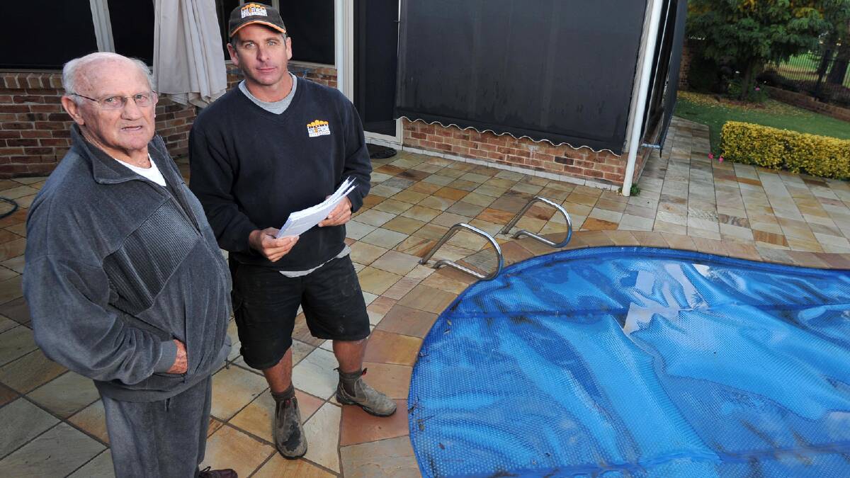 SAFETY CONCERNS: Arthur Summons and Troy Jones discuss Mr Summons’s pool and fencing requirements following new regulations. Picture: Michael Frogley