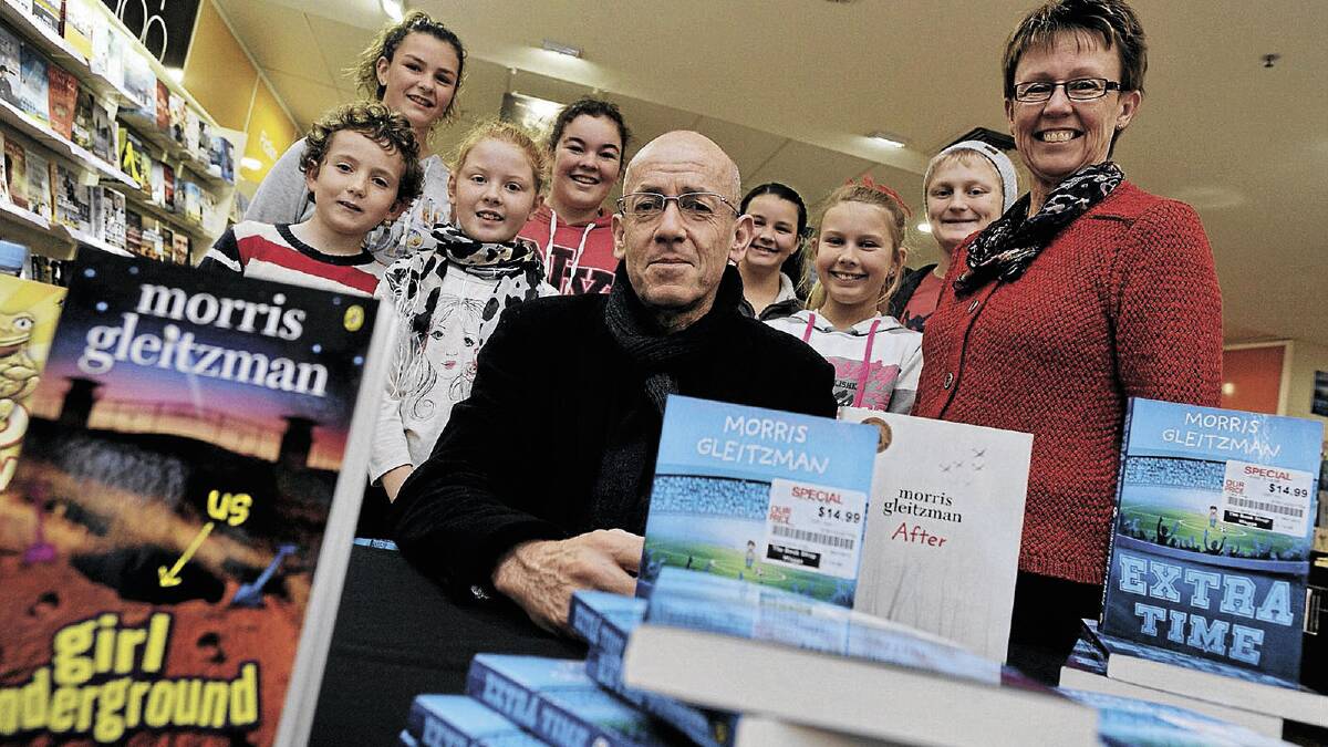 WRITE ON: Popular children’s book author Morris Gleitzman (centre) is surrounded by some of his biggest fans at The Book Shop in the Marketplace on Saturday. (From left) Matthew Barton, 9, Brandi Jones, 14, Isabel Fuller, 9, Caitlin Lugton, 13, Tess Jones, 11, Jess Stanley, 11, Blake Smith, 12 and store manager Sue Cobden. Picture: Alastair Brook