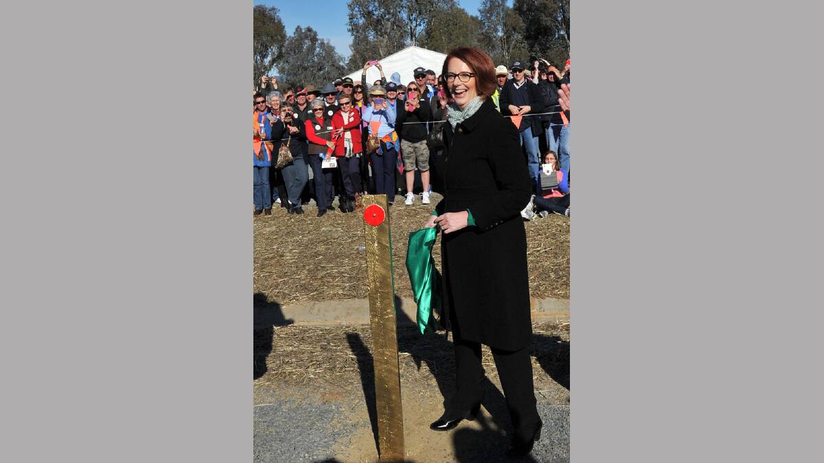 Prime Minister Julia Gillard unveils the golden guidepost. Picture: Michael Frogley