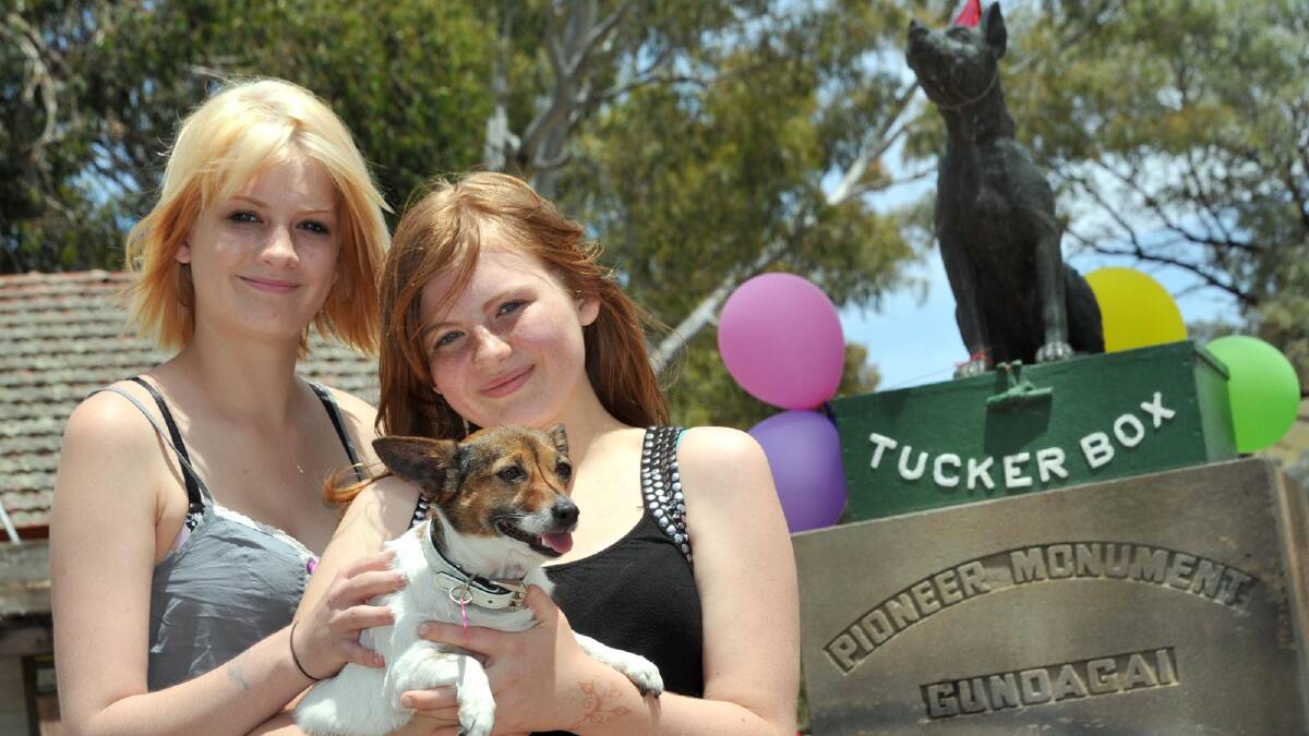 Taylah Horwood, 16, with her sister Breahna Horwood, 12, both from Wentworth near Mildura, and four-year-old Rosie. The girls adopted Rosie two years ago from the Riverina and District Animal Rescue (RADAR) stand that was at the Tuckerbox site. Picture: Les Smith