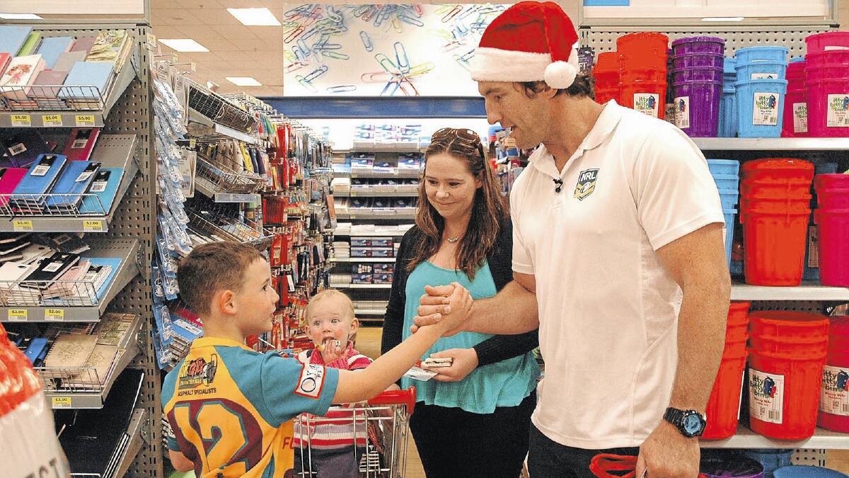 IN AWE: Nine year-old Briley Sentance shakes hands with former NRL star Nathan Hindmarsh after receiving surprise giftcards at The Marketplace in Wagga yesterday. Looking on in shock is Briley’s mother Kim Collins and his 14-month-old sister Isabella. Picture: Stephanie Muir