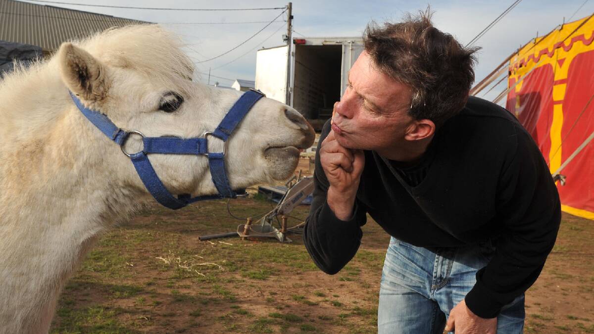 Carlos Gasser gets some affection from Merlin at Circus Olympia. Picture: Michael Frogley