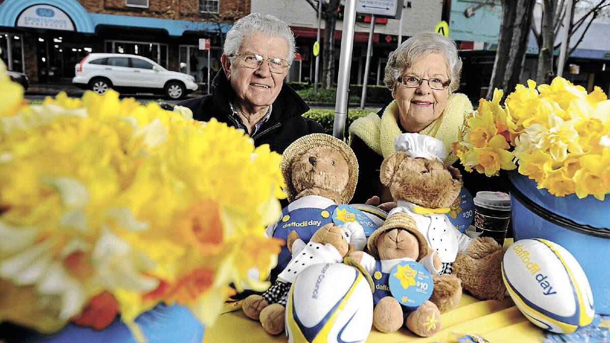 COLOUR AND HOPE: Trevor and Margaret Polsen were more than happy to brave the cold and volunteer to sell merchadise for Daffodil Day. Both have had family touched by cancer and say they were all too happy to do their part.  Picture: Alastair Brook