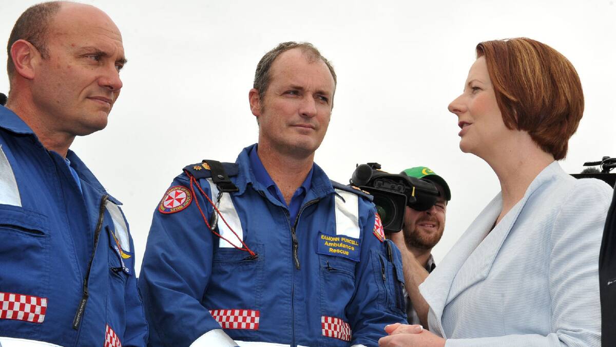 Prime Minister Julia Gillard meets with Ambulance officers Jason Watson and Eamonn Purcell. Picture: Michael Frogley