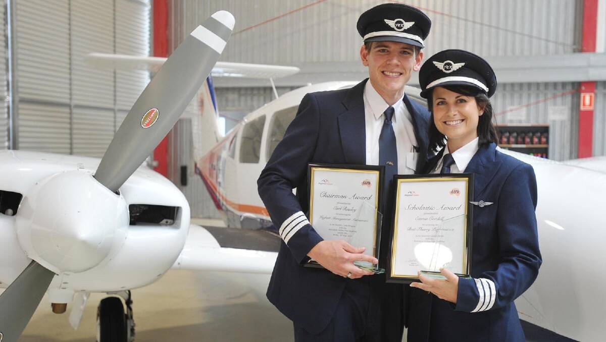 BIG STEP: Graduating Australian Airline Pilot Academy (AAPA) pilots Carl Riseley and Emma Cordell are ready for their next big adventure. Pictures: Alastair Brook