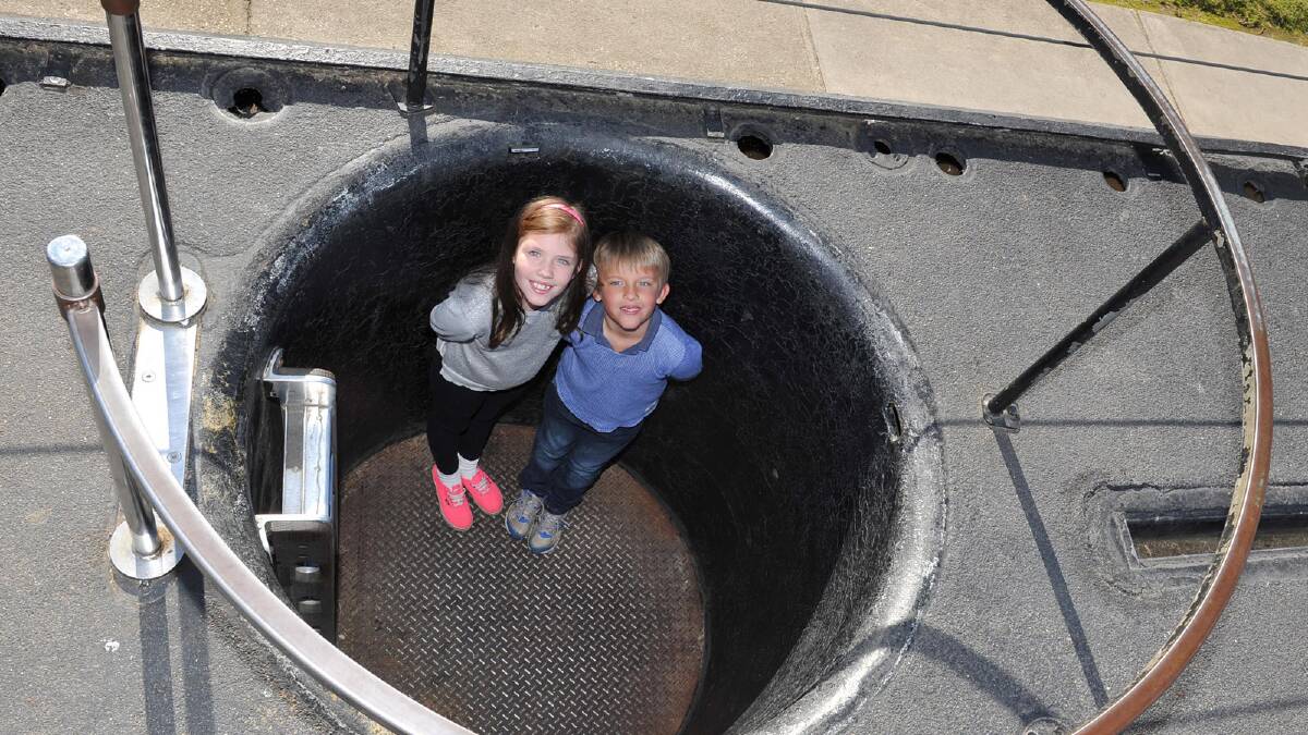 Laura, 9, and Lachlan, 6, Bunn of Albury explore the submarine at Holbrook. Picture: Michael Frogley
